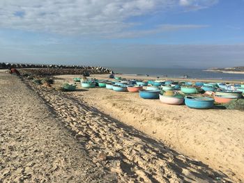 Boats moored on beach against sky