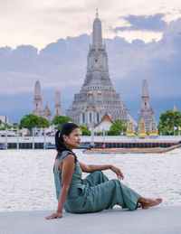 Portrait of young woman sitting at beach