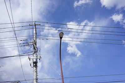 Low angle view of telephone line against blue sky