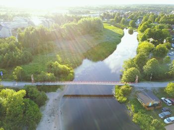 High angle view of river amidst trees against sky
