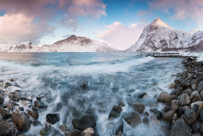 Panoramic shot of sea and rocks against sky