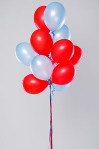 Many colorful balloons isolated on gray background