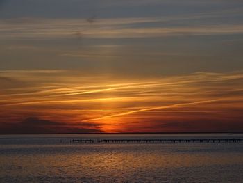 Scenic view of sea against orange sky