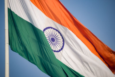 India flag flying high at connaught place with pride in blue sky, india flag fluttering, indian flag