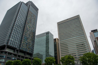 Low angle view of modern buildings against sky in city
