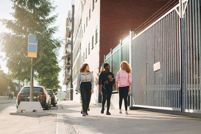 Group of people walking on street in city