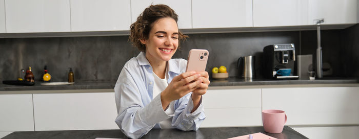 Portrait of young woman using mobile phone