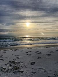 Scenic view of beach against sky during sunset