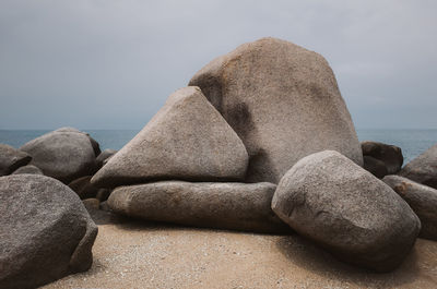 Rocks on beach against sky