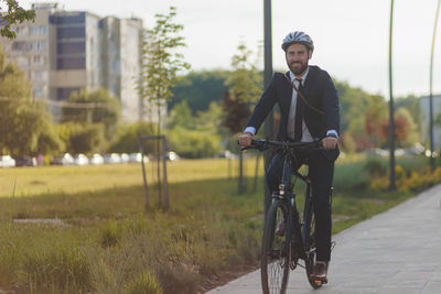 Portrait of man riding bicycle on road