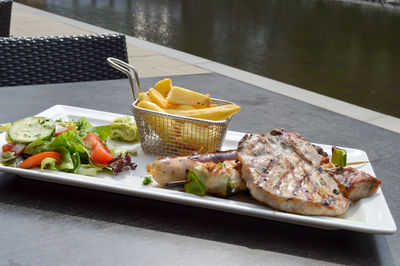 High angle view of food served in plate on table at sidewalk cafe