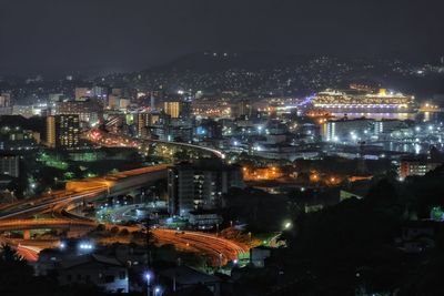 High angle view of illuminated buildings in city at night