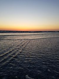 Scenic view of sea against clear sky during sunset