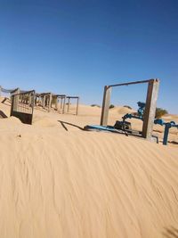 Low angle view of built structure on beach against clear sky