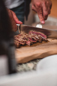 Close-up of person preparing food on cutting board