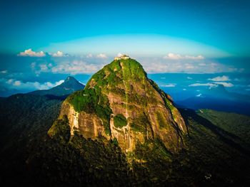 Scenic view of mountains against blue sky