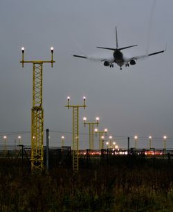 Airplane flying against sky at night