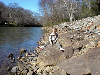 Full length of woman standing on rocks