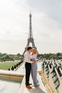 Full length of man and woman standing against sky