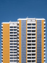 Residential buildings against blue sky