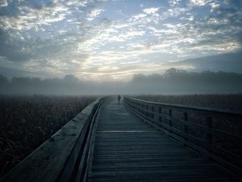 Railroad tracks against sky during winter