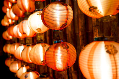 Low angle view of illuminated lanterns hanging in row