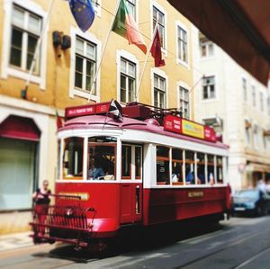 View of red car on city street