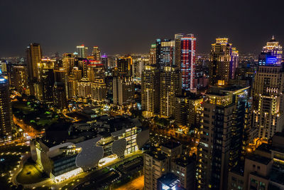 High angle view of illuminated buildings in city at night