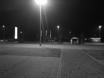 Illuminated street lights in city at night