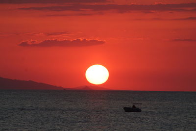 Scenic view of sea against orange sky