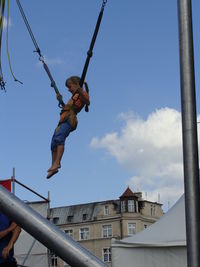 Low angle view of boy swing