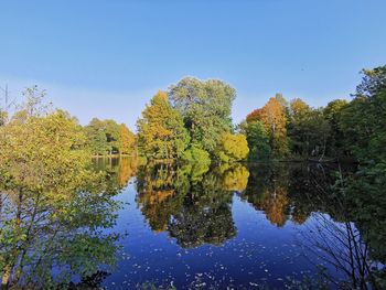 Reflection of trees in lake against sky during autumn