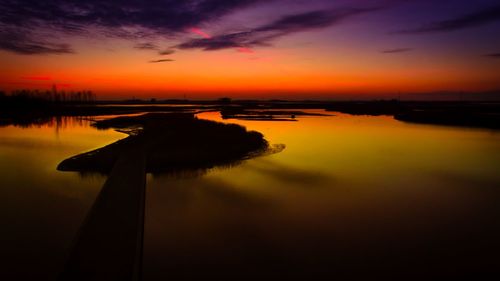 Scenic view of lake against sky during sunset