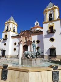 Low angle view of statues on building against sky