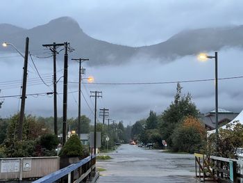 Street amidst mountains against sky