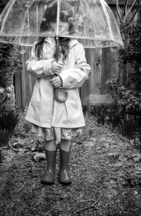 Full length of woman standing in rain