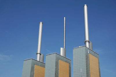 Low angle view of tower against blue sky