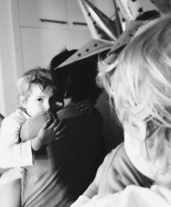 Rear view of two women sitting at home