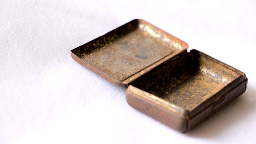 Close-up of metal object over white background