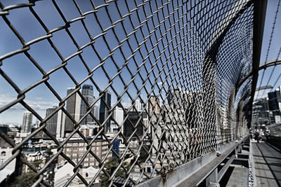 Close-up of chainlink fence in city