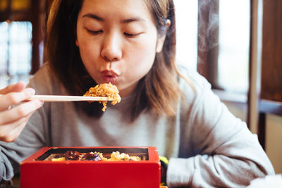 Woman blowing rice at home