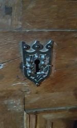 Close-up of door knocker on wooden wall