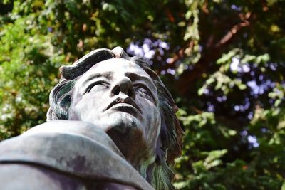 Low angle view of statue against trees