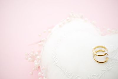 Close-up of wedding rings in heart shape decoration