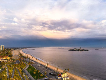 High angle view of sea and cityscape against sky