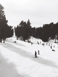 People walking on snow covered landscape