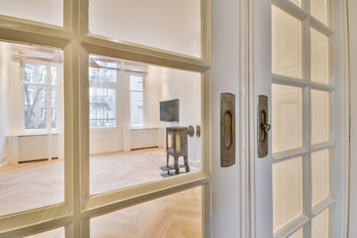 Rear view of woman looking through window