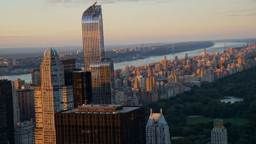 Panoramic view of buildings in city against sky during sunset