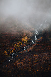 View of waterfall during autumn on a foogy day