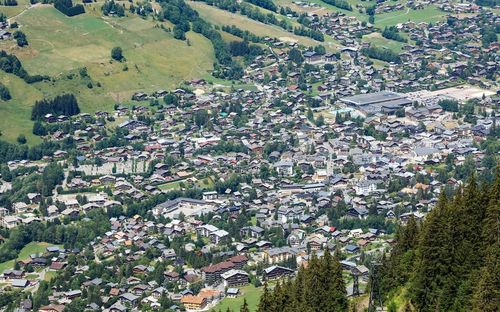 High angle view of townscape and felds next to a city of megève in france. 